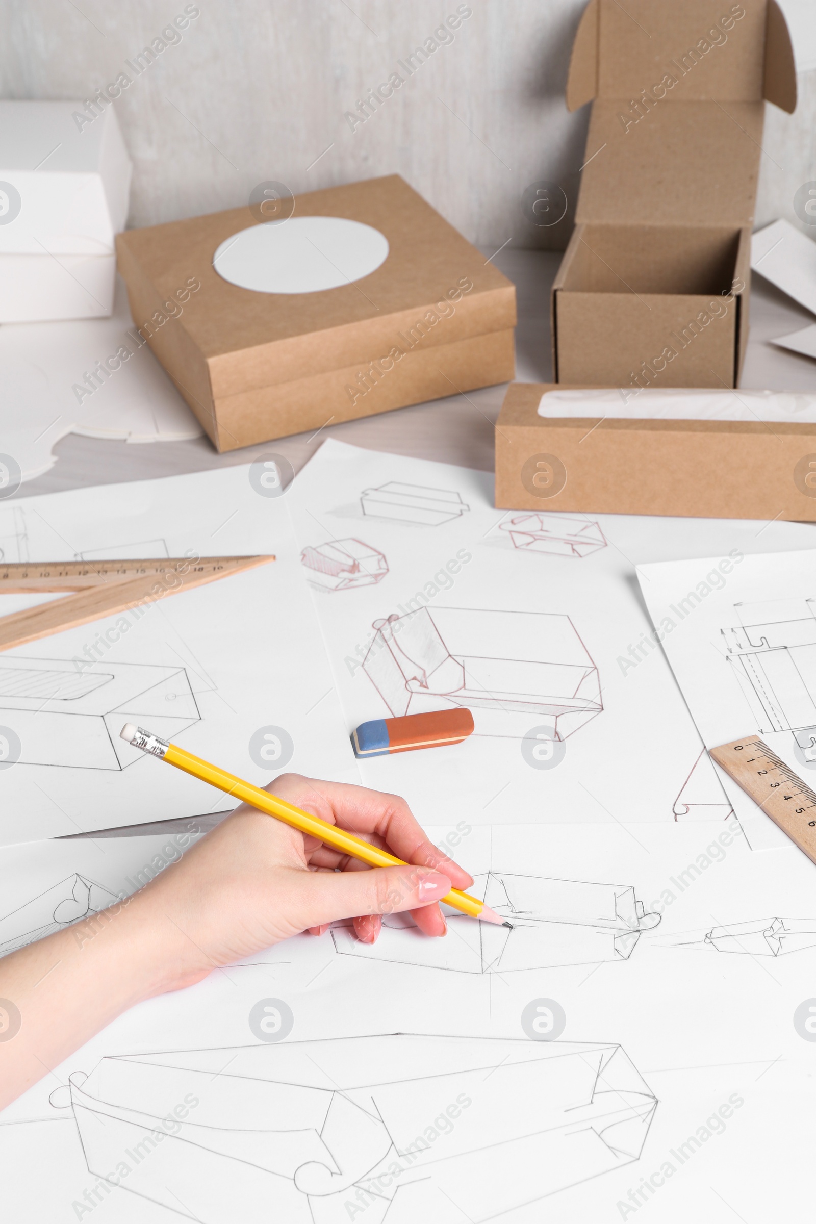 Photo of Woman creating packaging design at table, closeup