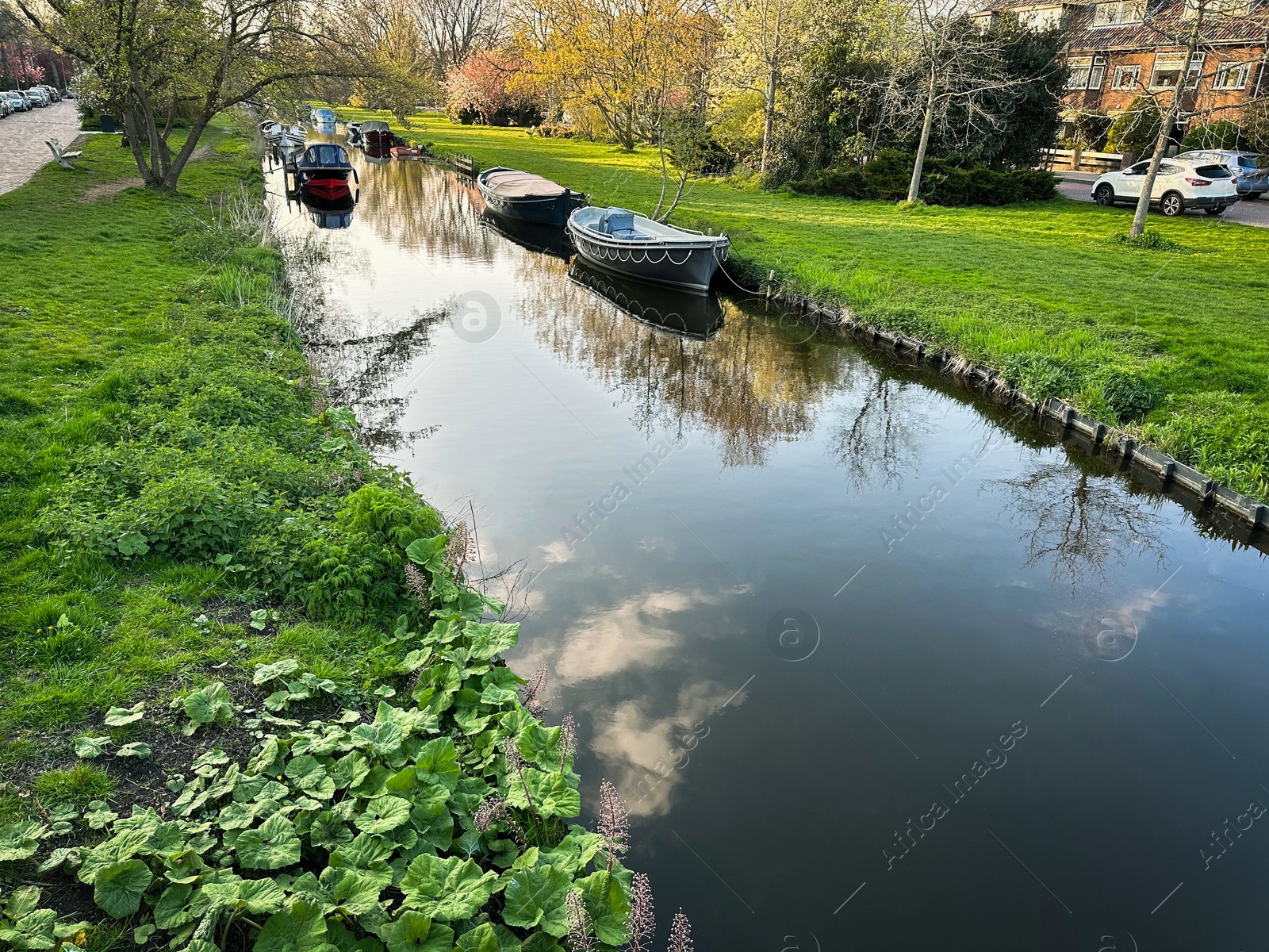 Photo of Beautiful view of canal with moored boats in city