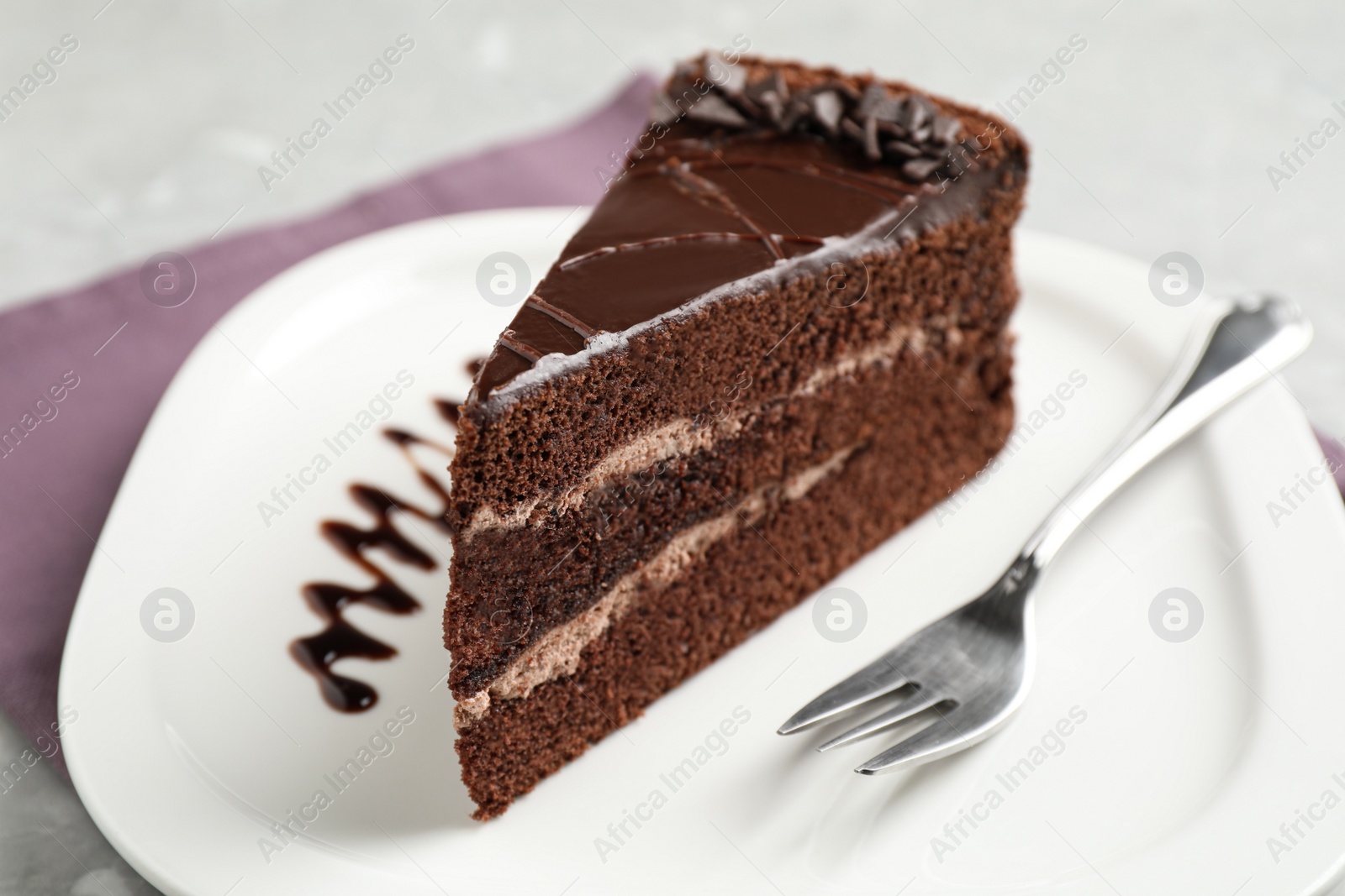 Photo of Piece of tasty chocolate cake served on plate