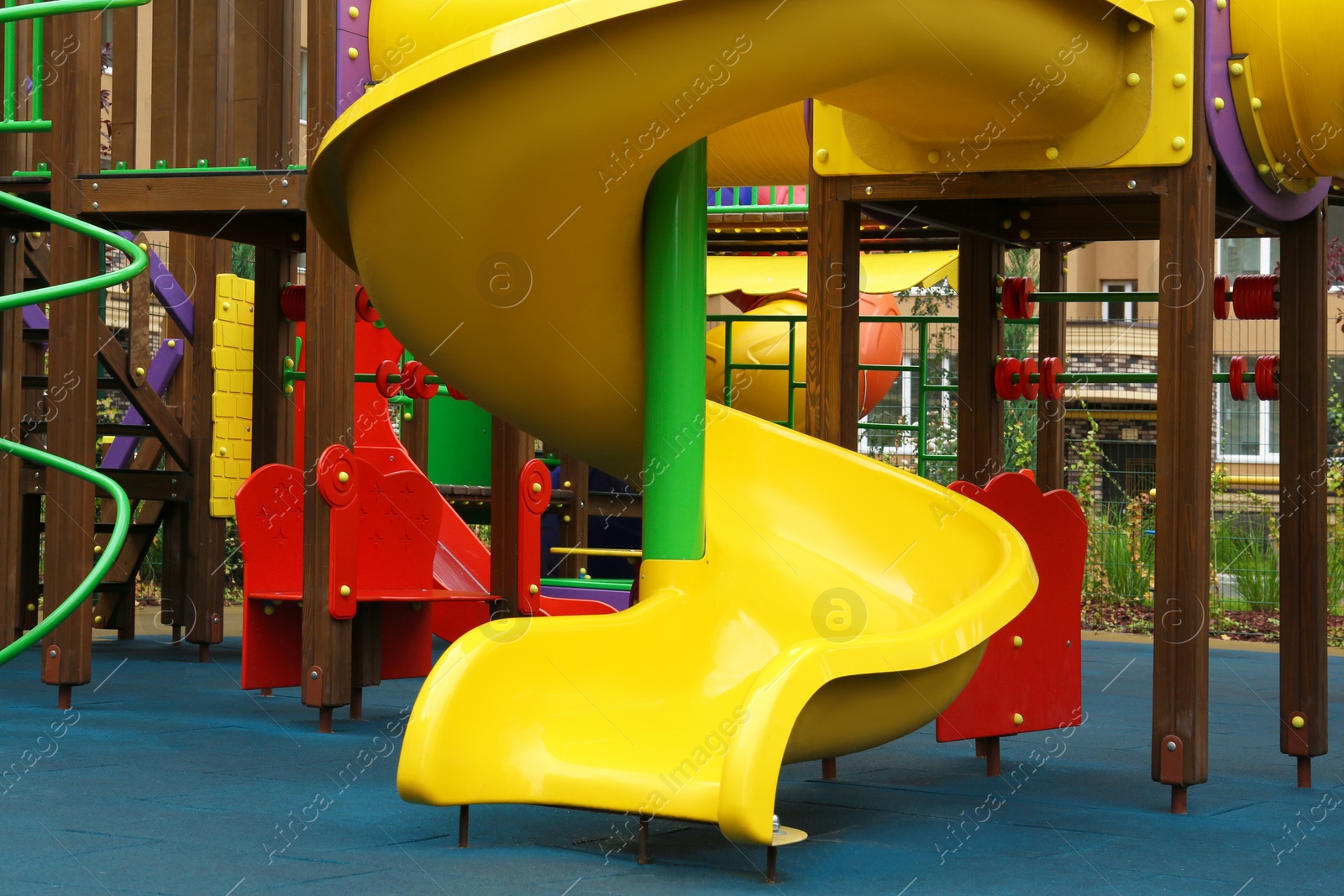 Photo of Colourful slide on outdoor playground for children in residential area