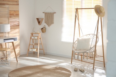 Comfortable hammock chair in stylish room. Home interior