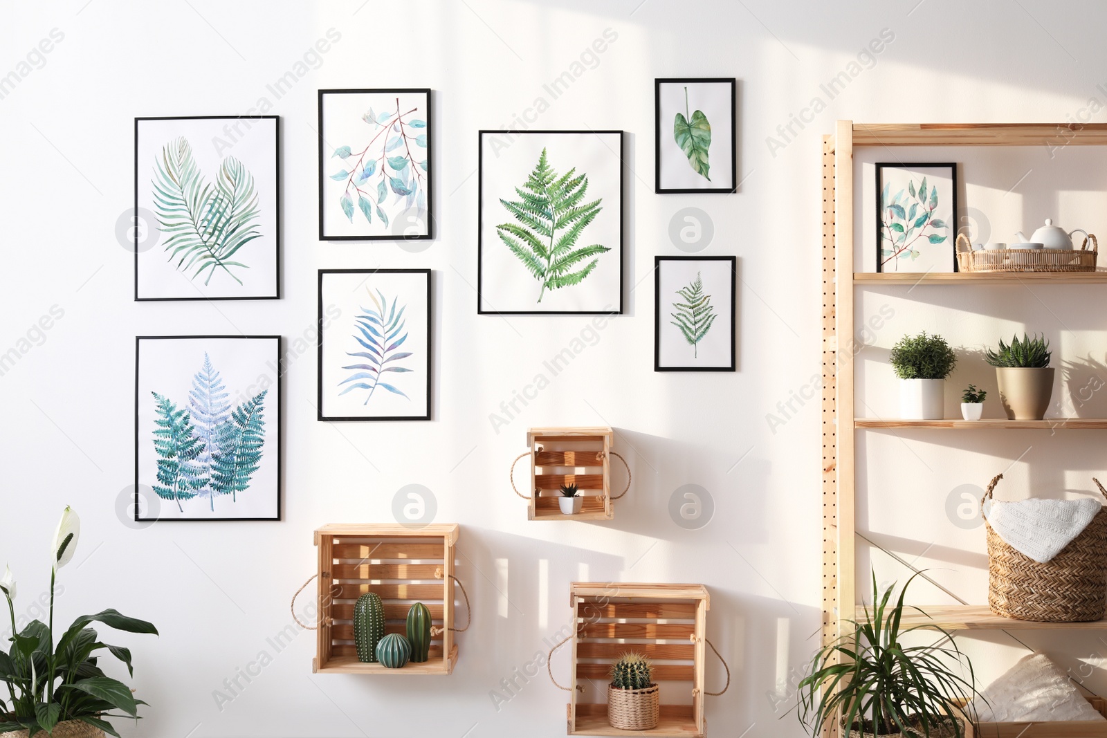 Photo of Beautiful paintings of tropical leaves and houseplants in room