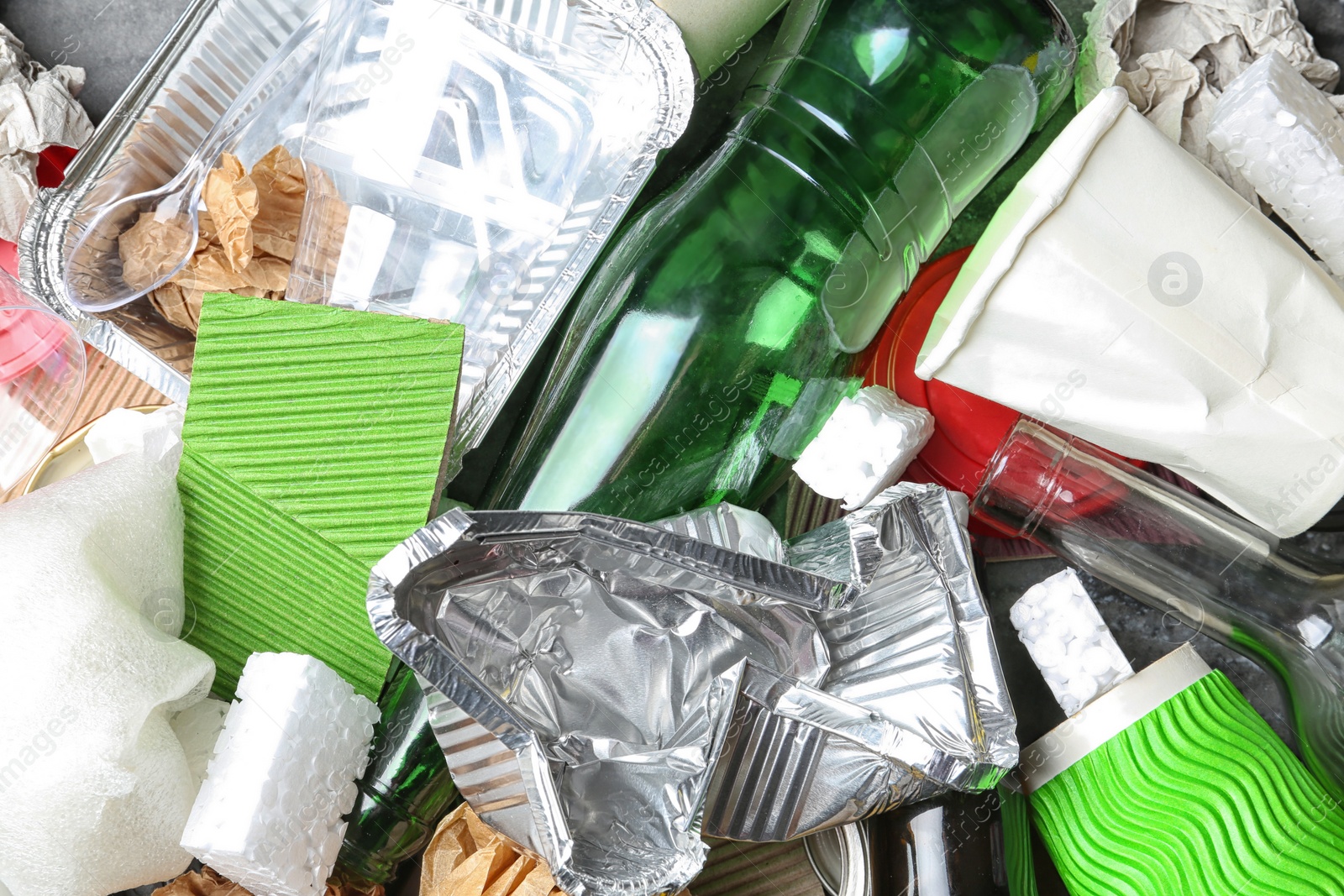 Photo of Pile of different garbage as background, top view. Recycling problem