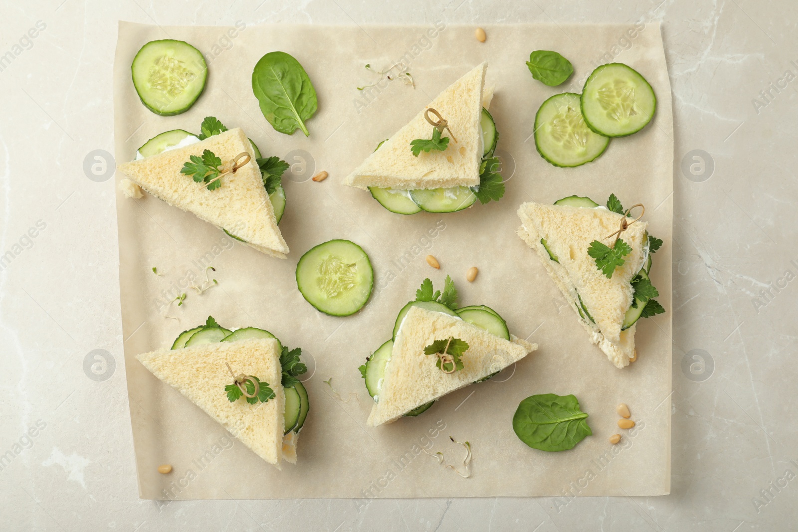 Photo of Flat lay composition with traditional English cucumber sandwiches on parchment