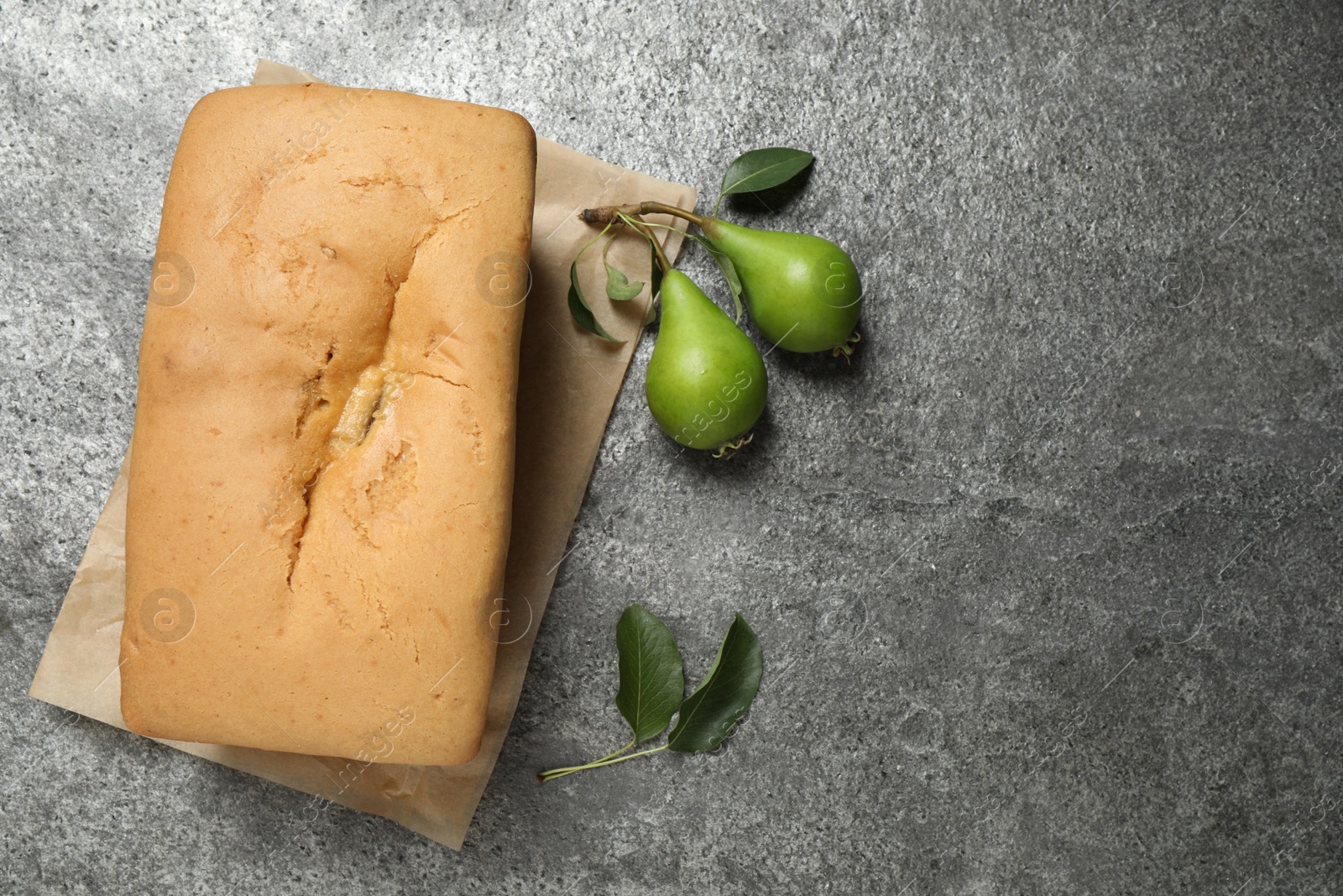 Photo of Tasty bread and pears on grey table, flat lay 
 with space for text. Homemade cake