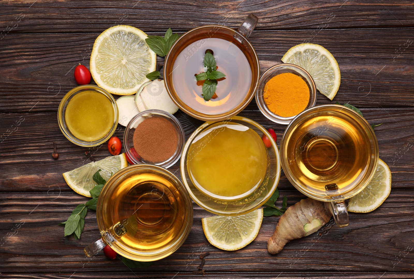 Photo of Flat lay composition of tea with honey and ingredients on wooden table