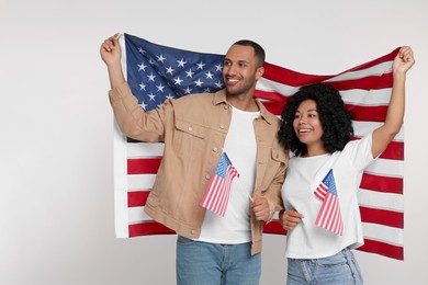 Photo of 4th of July - Independence Day of USA. Happy couple with American flags on white background