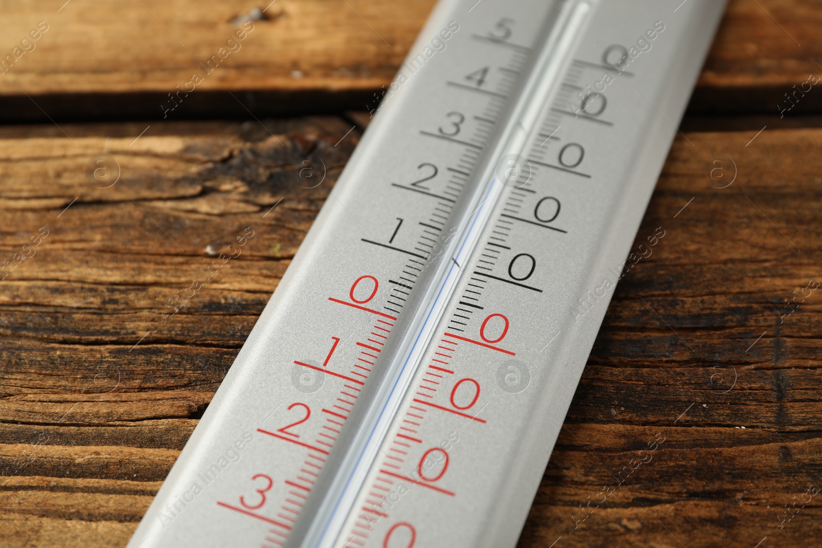 Photo of Modern weather thermometer on wooden background, closeup