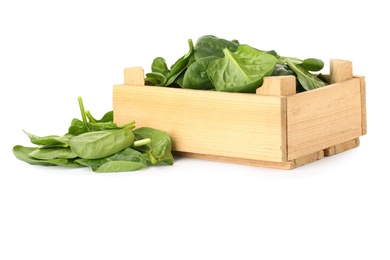 Crate and spinach leaves isolated on white