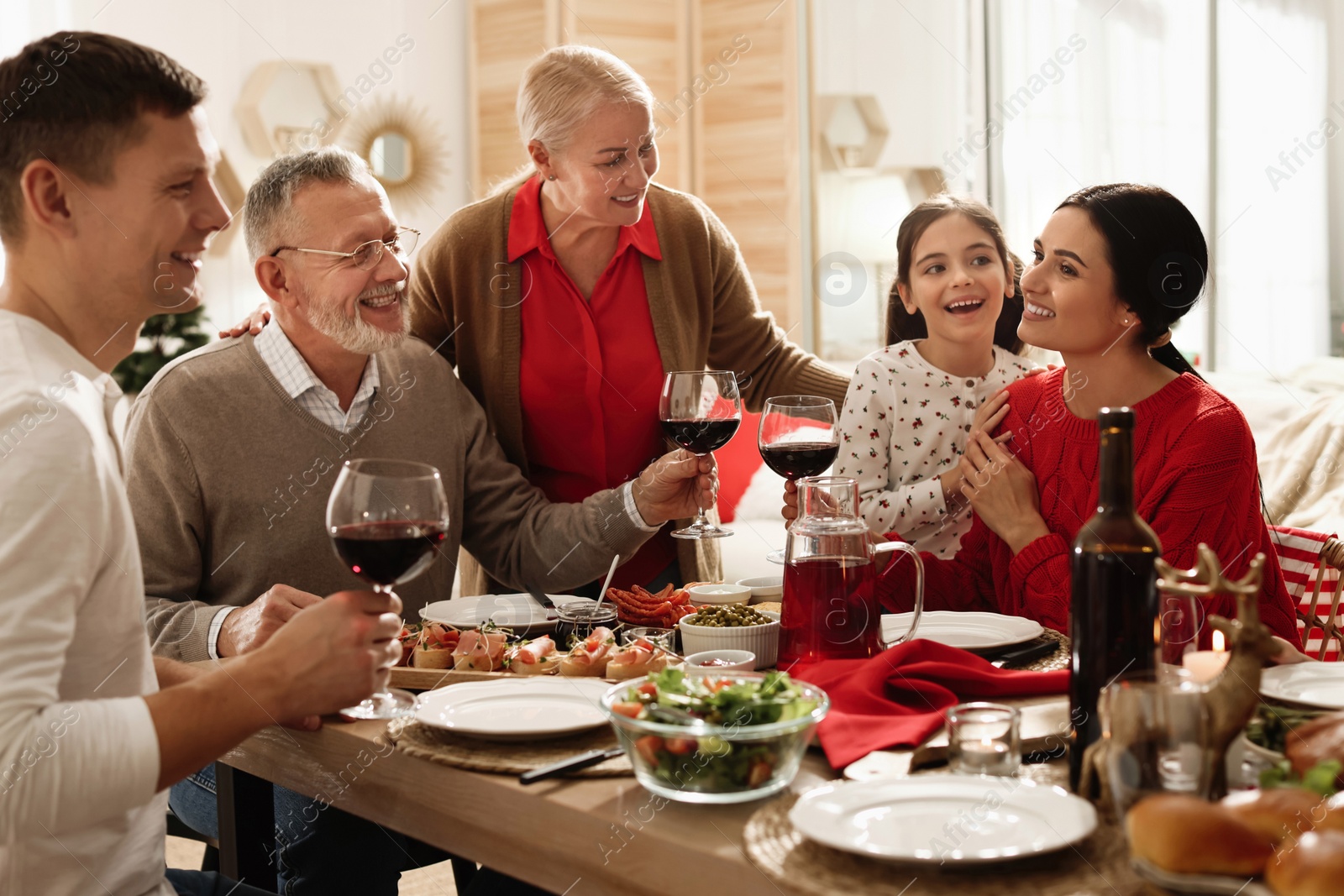 Photo of Happy family enjoying festive dinner at home. Christmas celebration