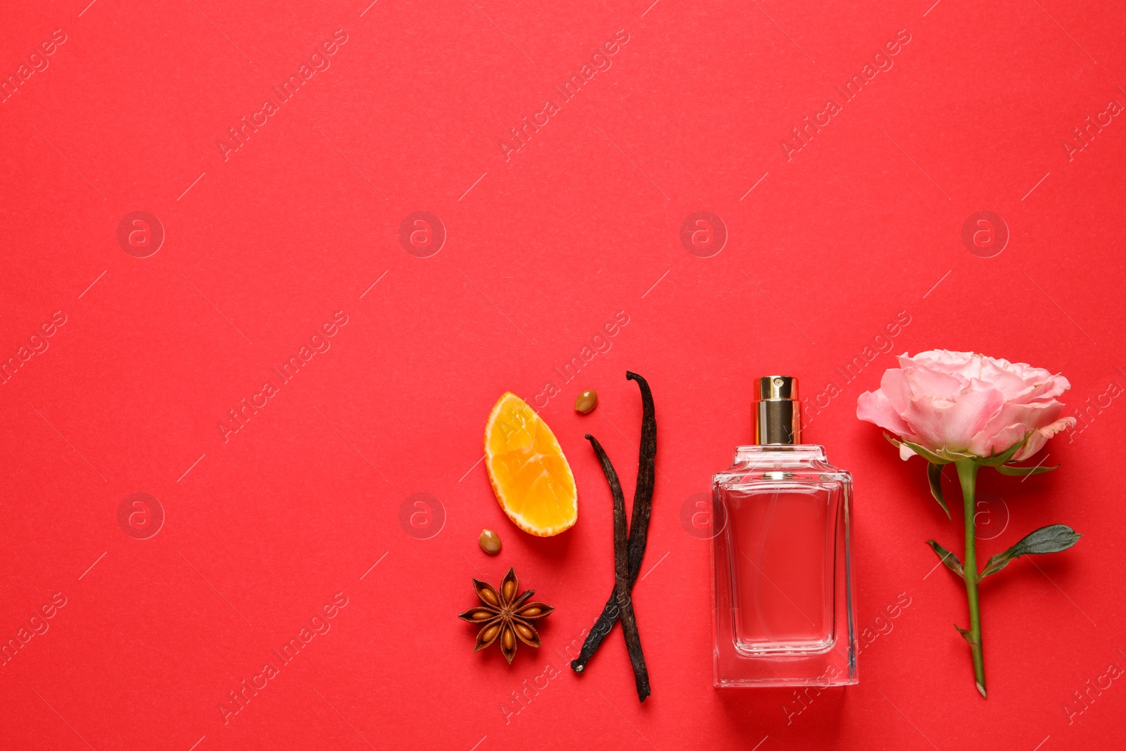 Photo of Flat lay composition with bottle of perfume and fresh citrus fruit on red background. Space for text