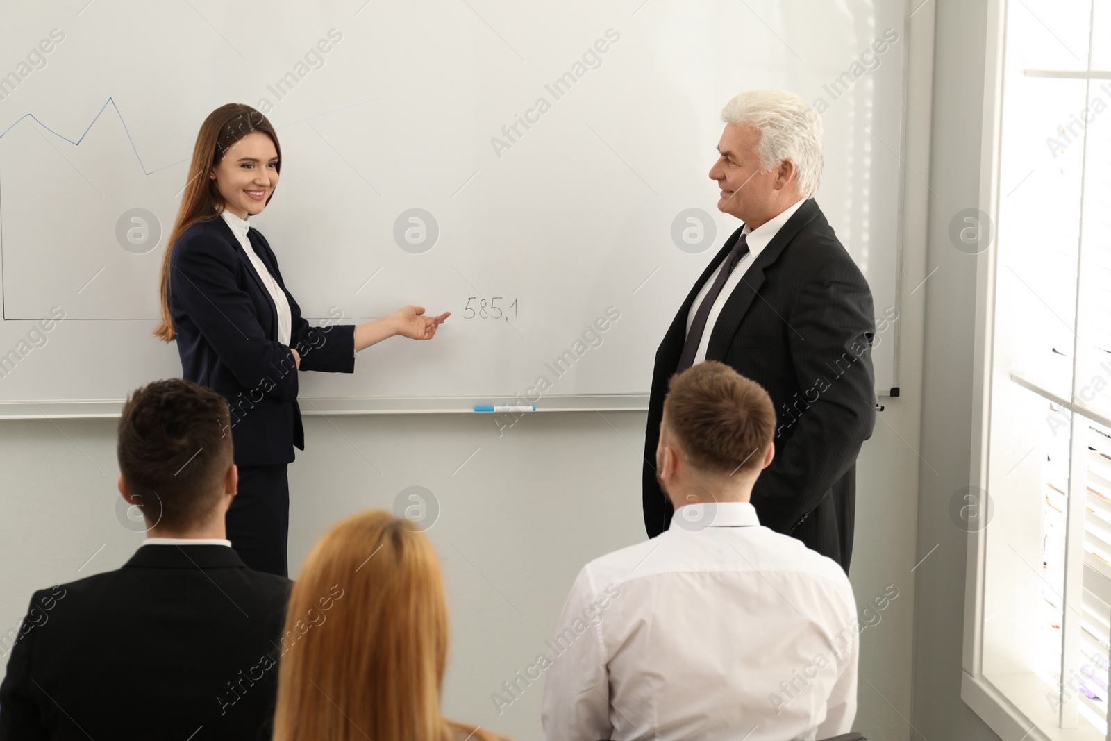 Photo of Professional business trainer working with people in office