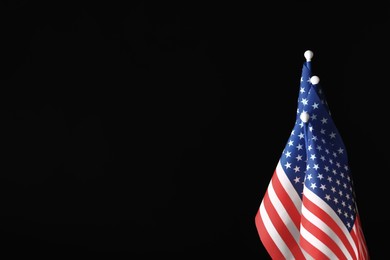 Photo of American flags on black background, space for text. Memorial Day