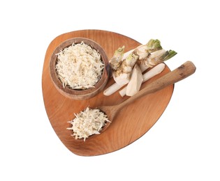 Photo of Board with grated horseradish, cut roots and spoon isolated on white, top view