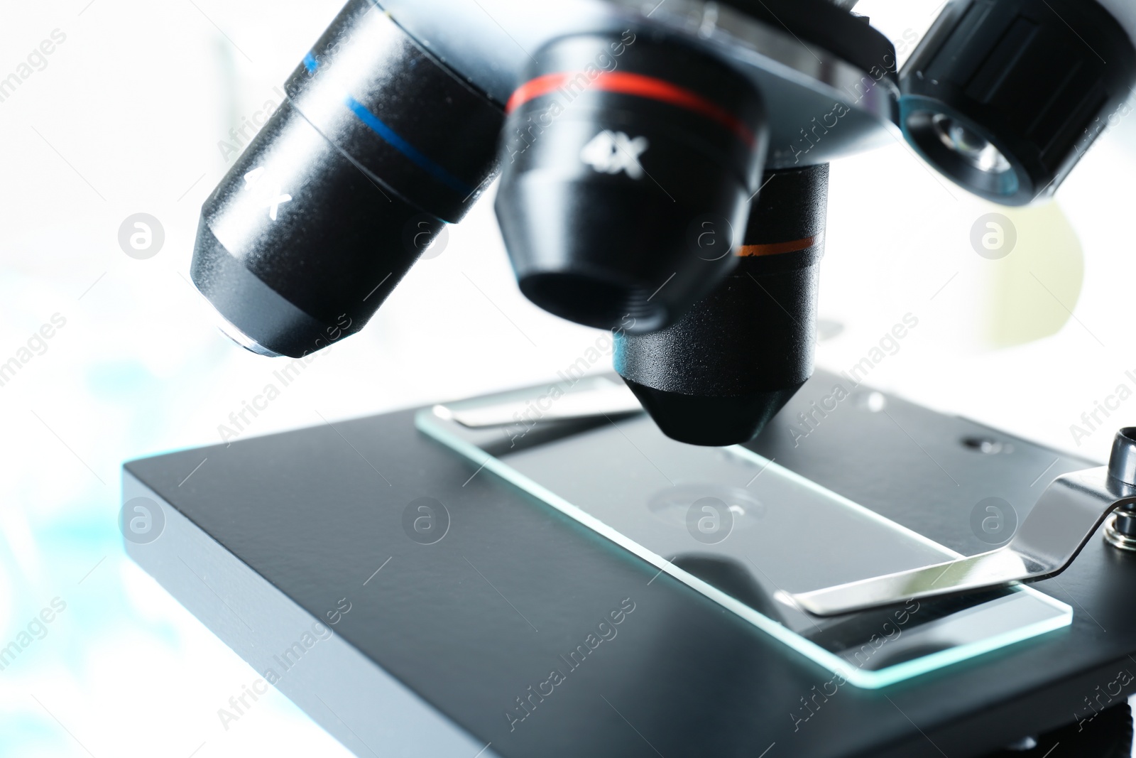 Photo of Modern microscope with different lenses, closeup. Chemical research