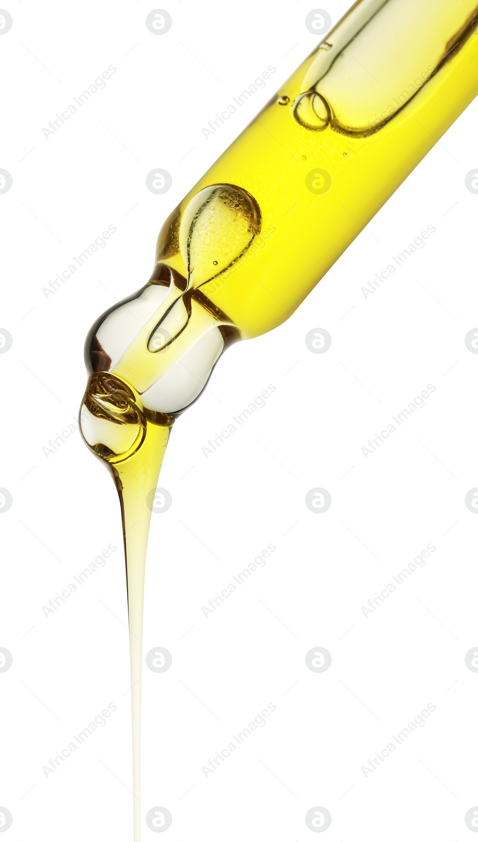 Photo of Dripping yellow facial serum from pipette on white background, closeup