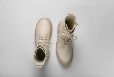 Pair of stylish leather shoes on beige background, flat lay