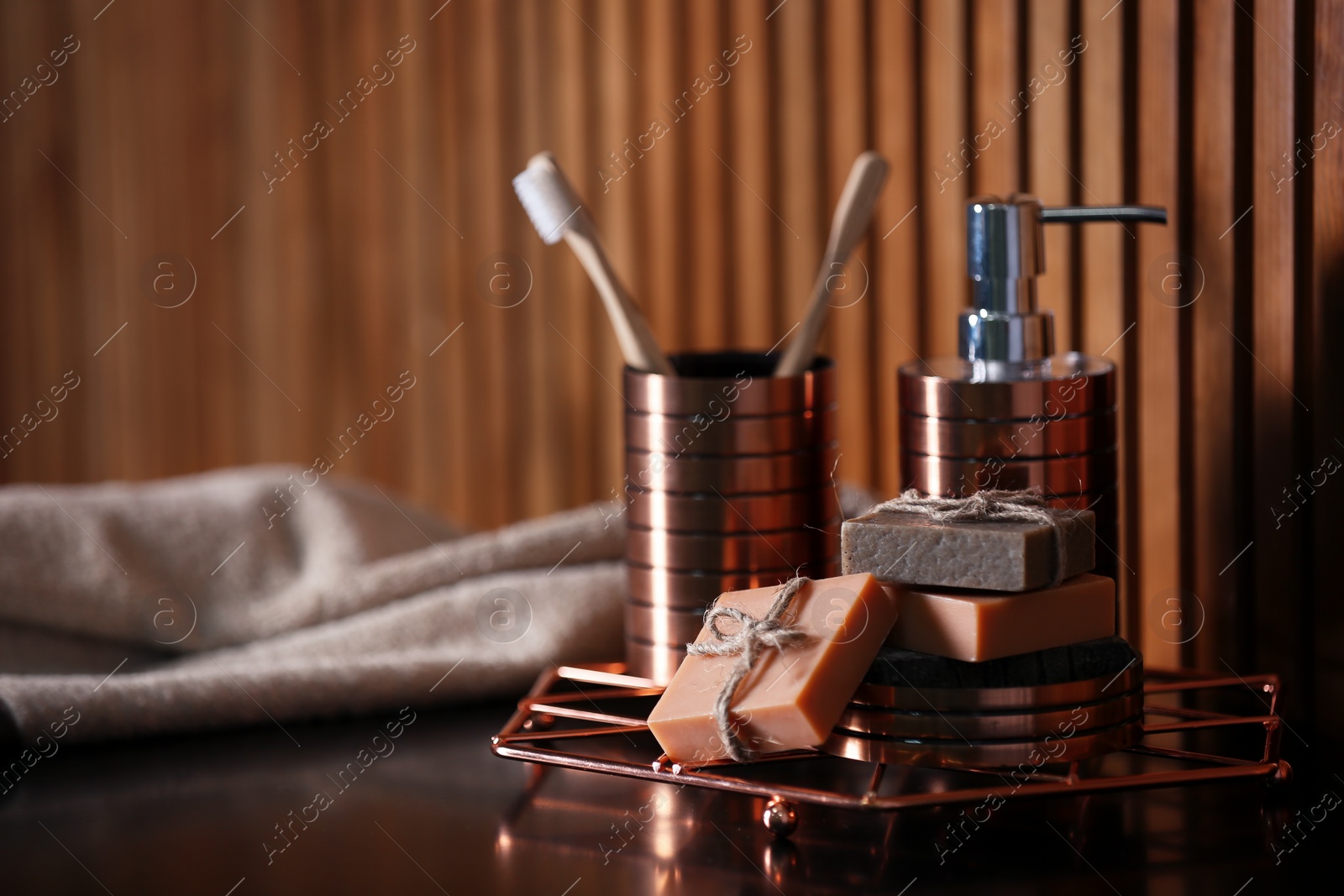 Photo of Soap bars, shampoo and toiletries on table. Space for text