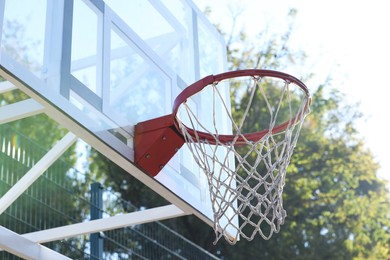 Photo of Basketball hoop with net outdoors on sunny day