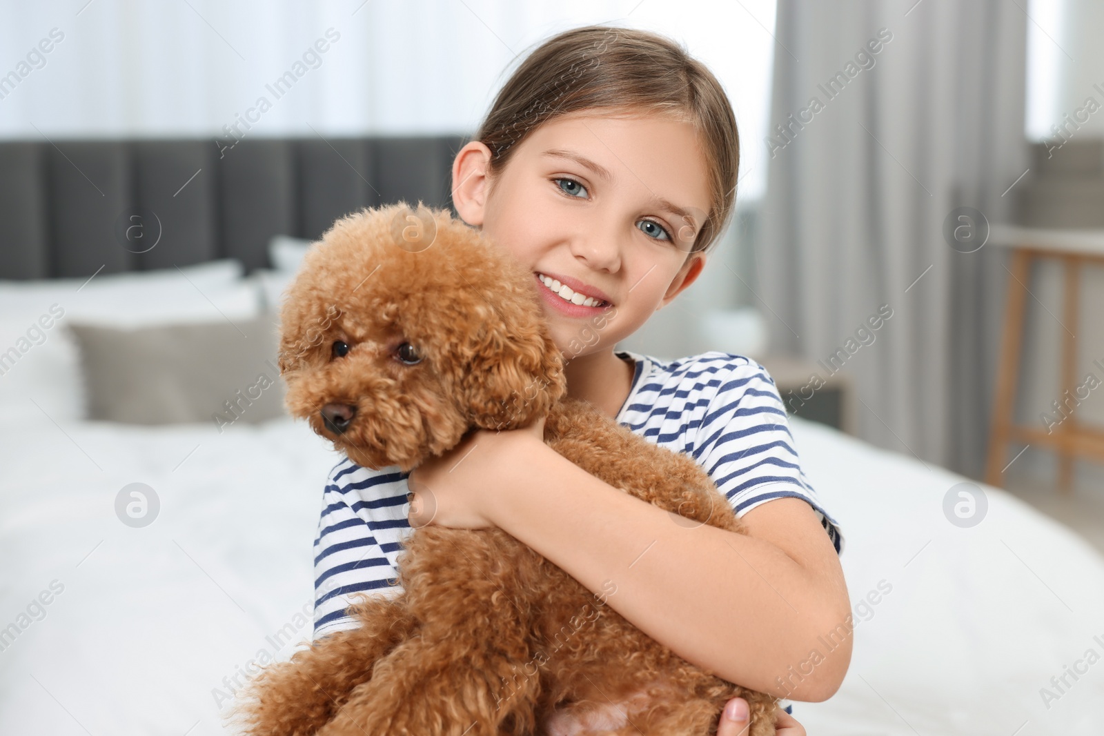 Photo of Little child with cute puppy at home. Lovely pet