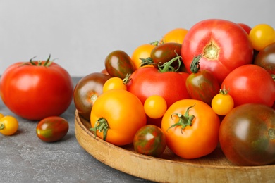Photo of Many fresh ripe tomatoes on grey table