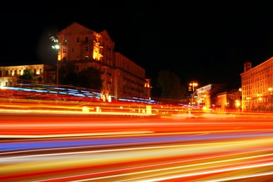 Road traffic, motion blur effect. View of night cityscape with car light trails