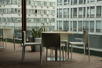 Photo of Observation area cafe. Table and chairs against beautiful cityscape