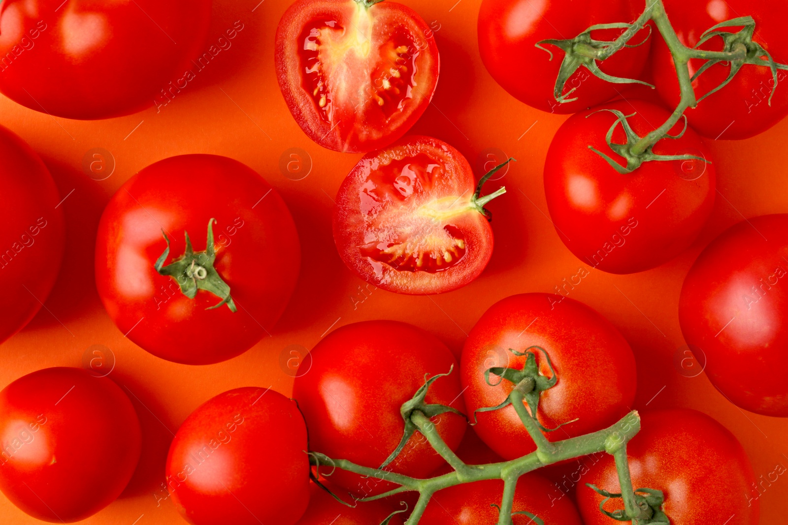 Photo of Flat lay composition with fresh ripe tomatoes on orange background