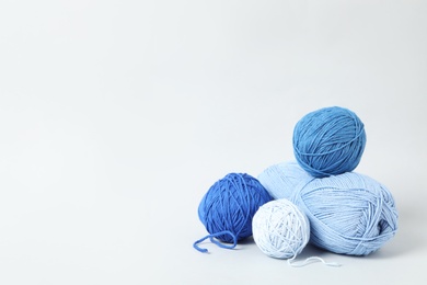 Photo of Soft colorful woolen yarns on white background