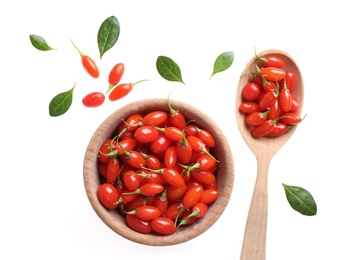 Fresh ripe goji berries, bowl and spoon on white background, top view