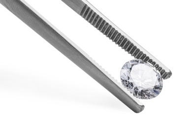 Photo of Tweezers with beautiful shiny diamond isolated on white