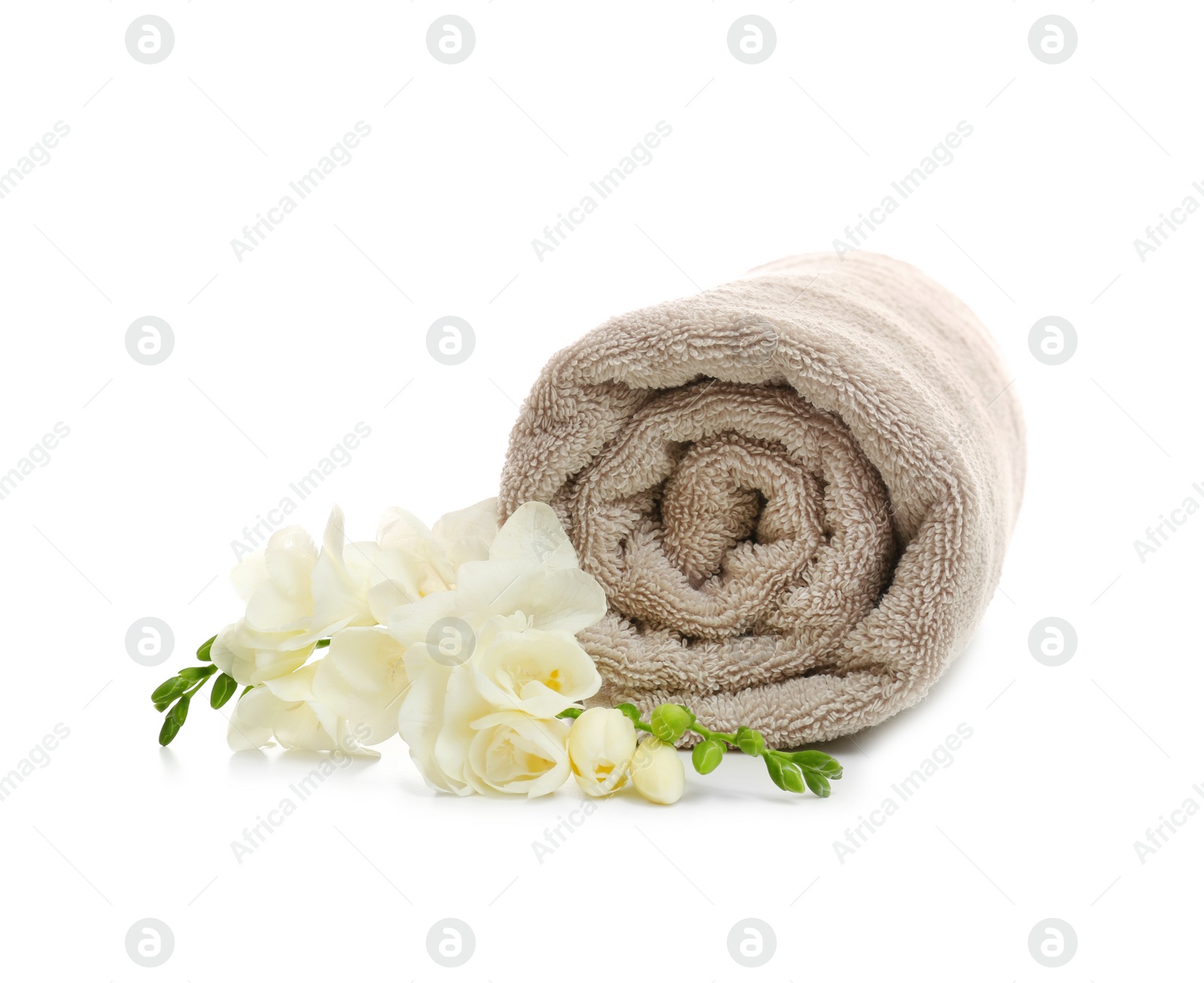 Photo of Clean rolled towel with flowers on white background