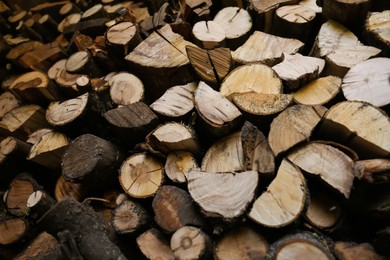 Stacked firewood as background, low angle view. Heating house in winter