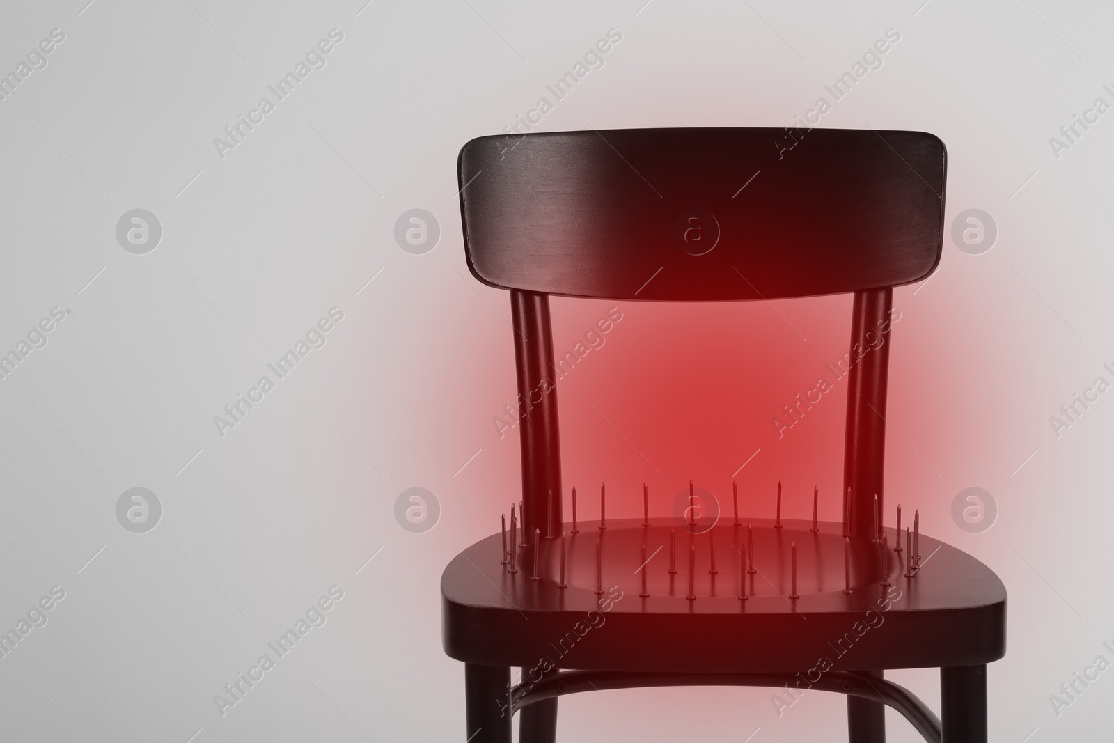 Image of Hemorrhoid concept. Chair with iron nails isolated on white