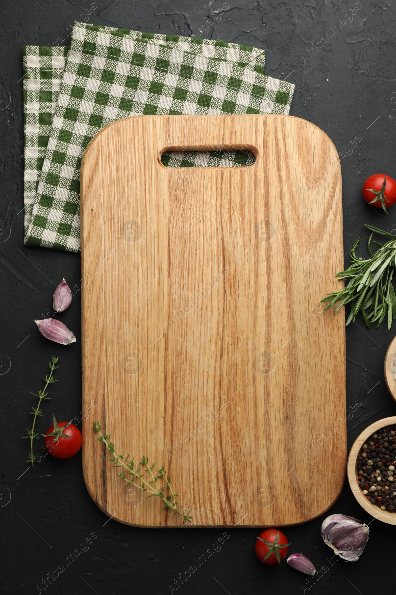 Photo of Cutting board, fresh tomatoes and different spices on grey textured table, flat lay