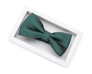 Photo of Stylish green bow tie with polka dot pattern on white background, top view