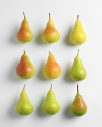 Fresh pears on light background, flat lay composition