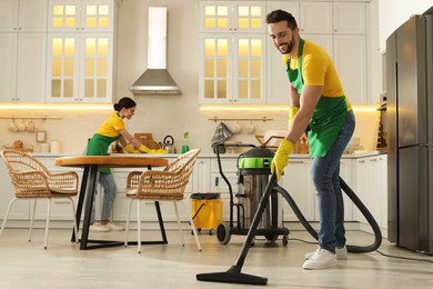 Photo of Professional janitors working in apartment. Cleaning service