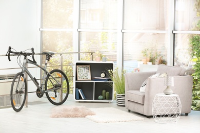 Modern apartment interior with bicycle near railings