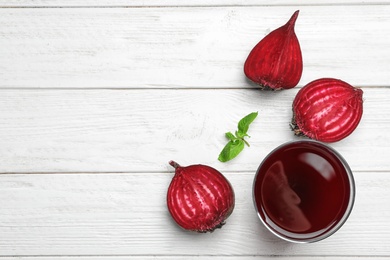 Photo of Flat lay composition with fresh beet juice on white wooden background. Space for text