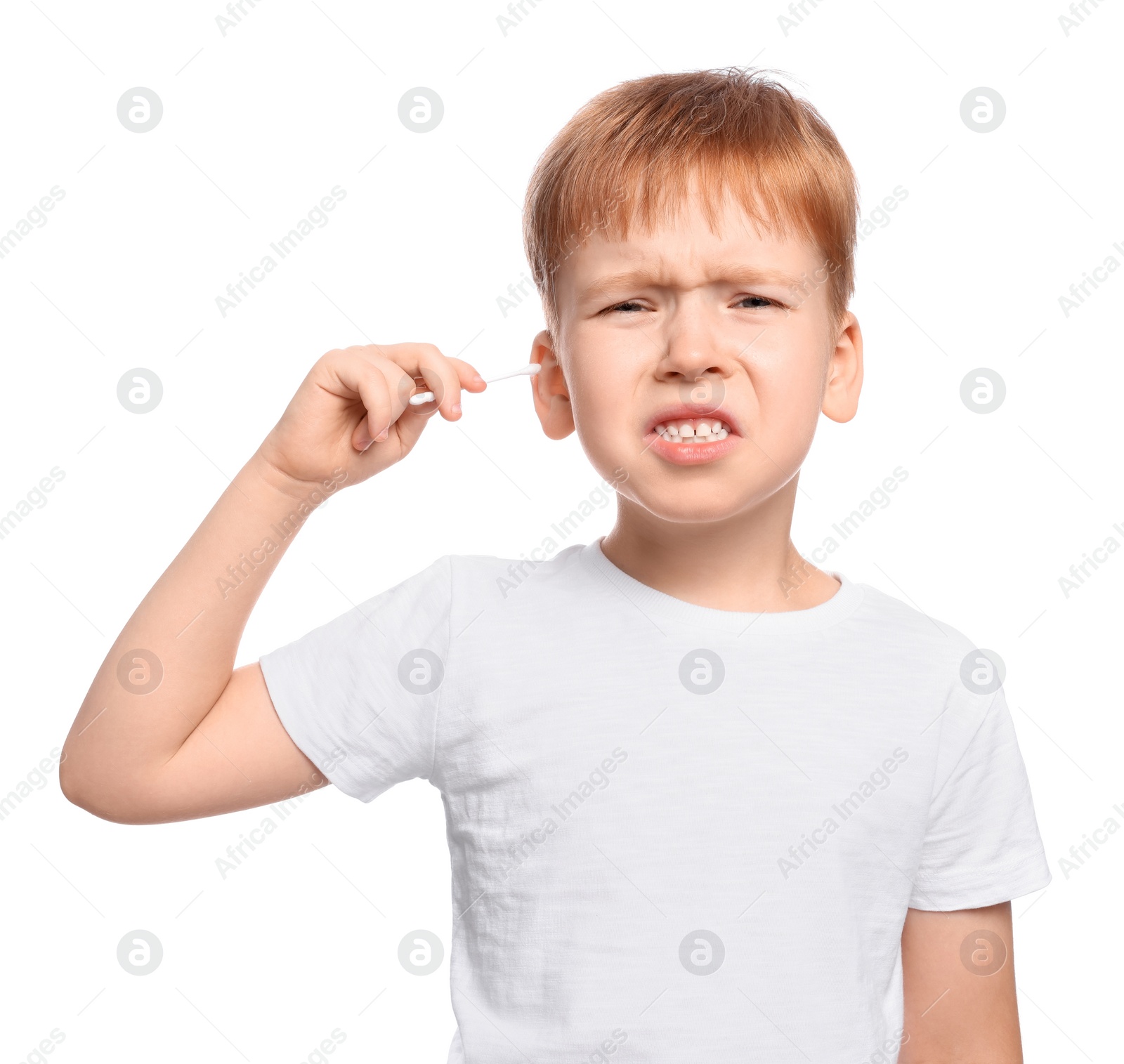 Photo of Little boy cleaning ear with cotton swab on white background