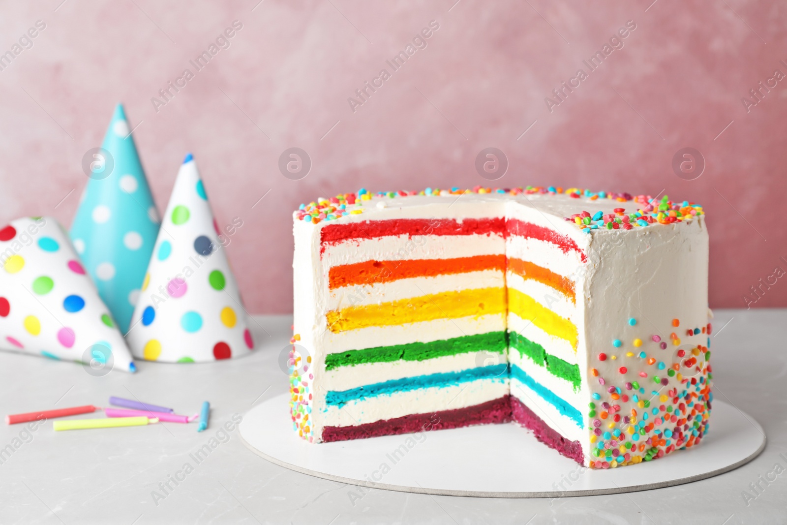 Photo of Delicious rainbow cake for party on table