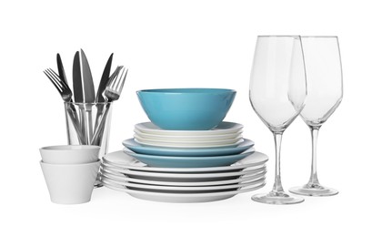 Set of beautiful ceramic dishware, glasses and cutlery isolated on white