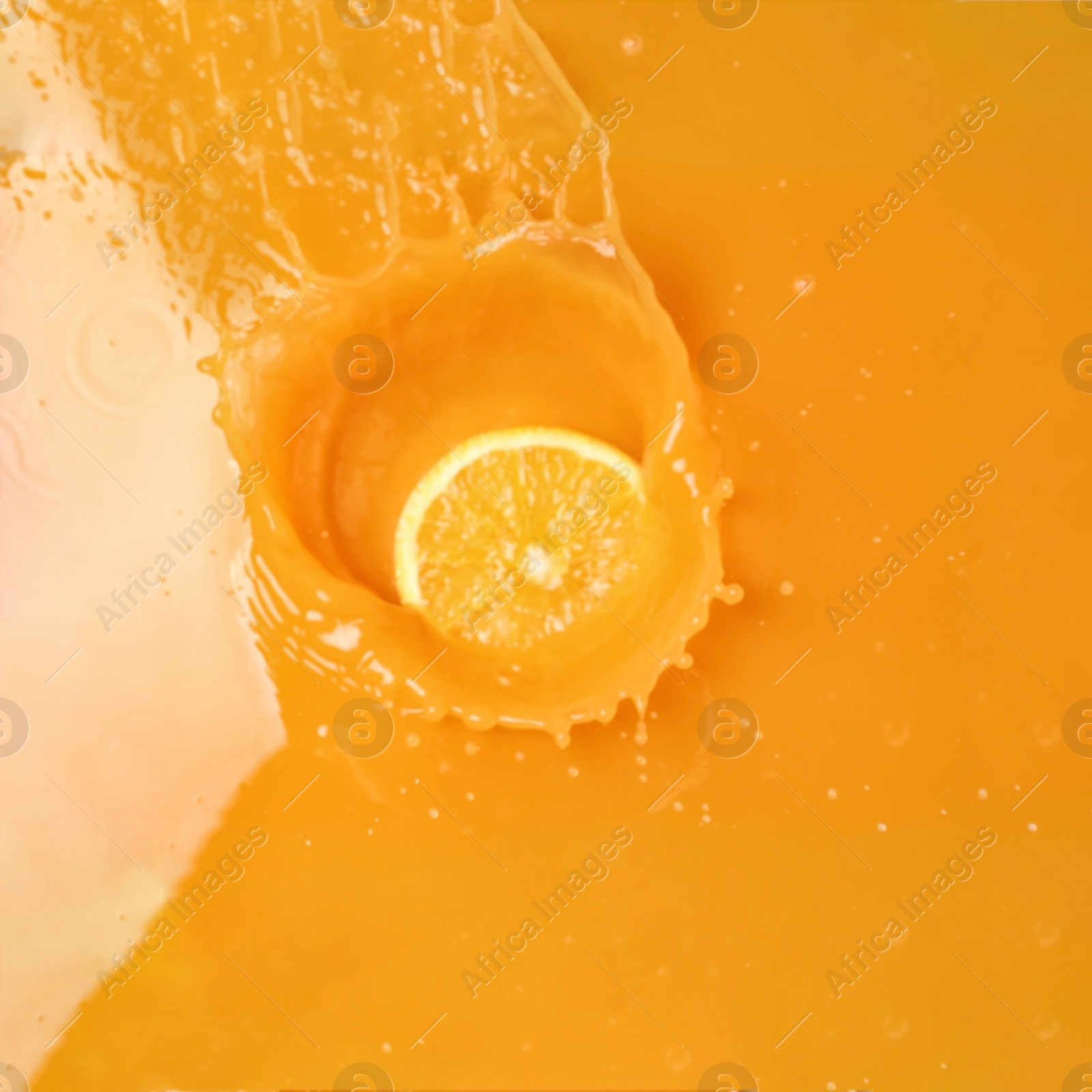 Photo of Delicious orange slice in juice, top view