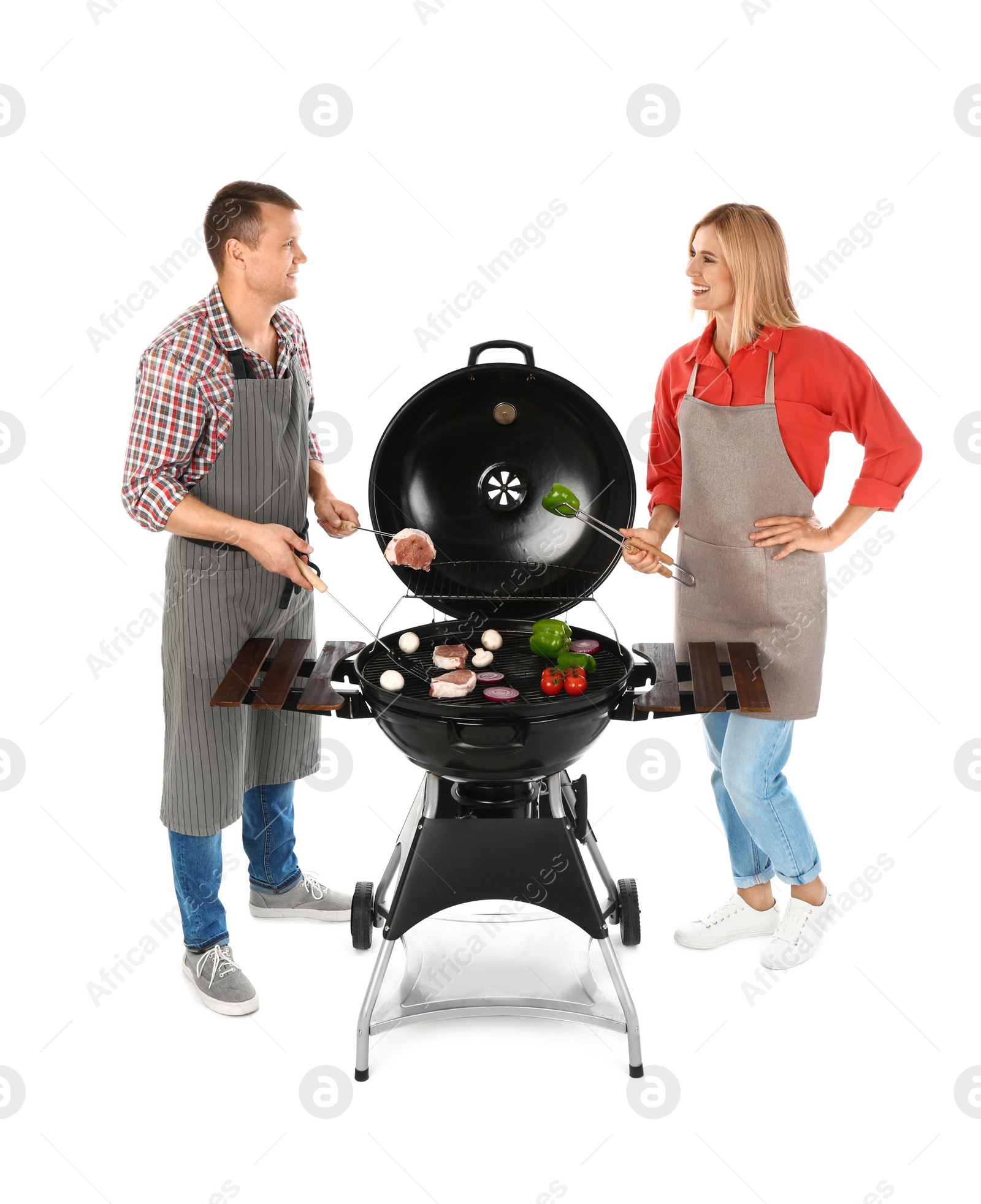 Photo of Happy couple cooking on barbecue grill, white background