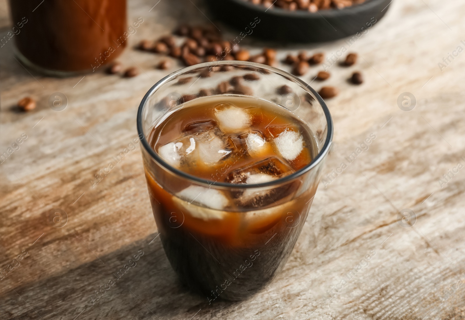 Photo of Glass with cold brew coffee on wooden table