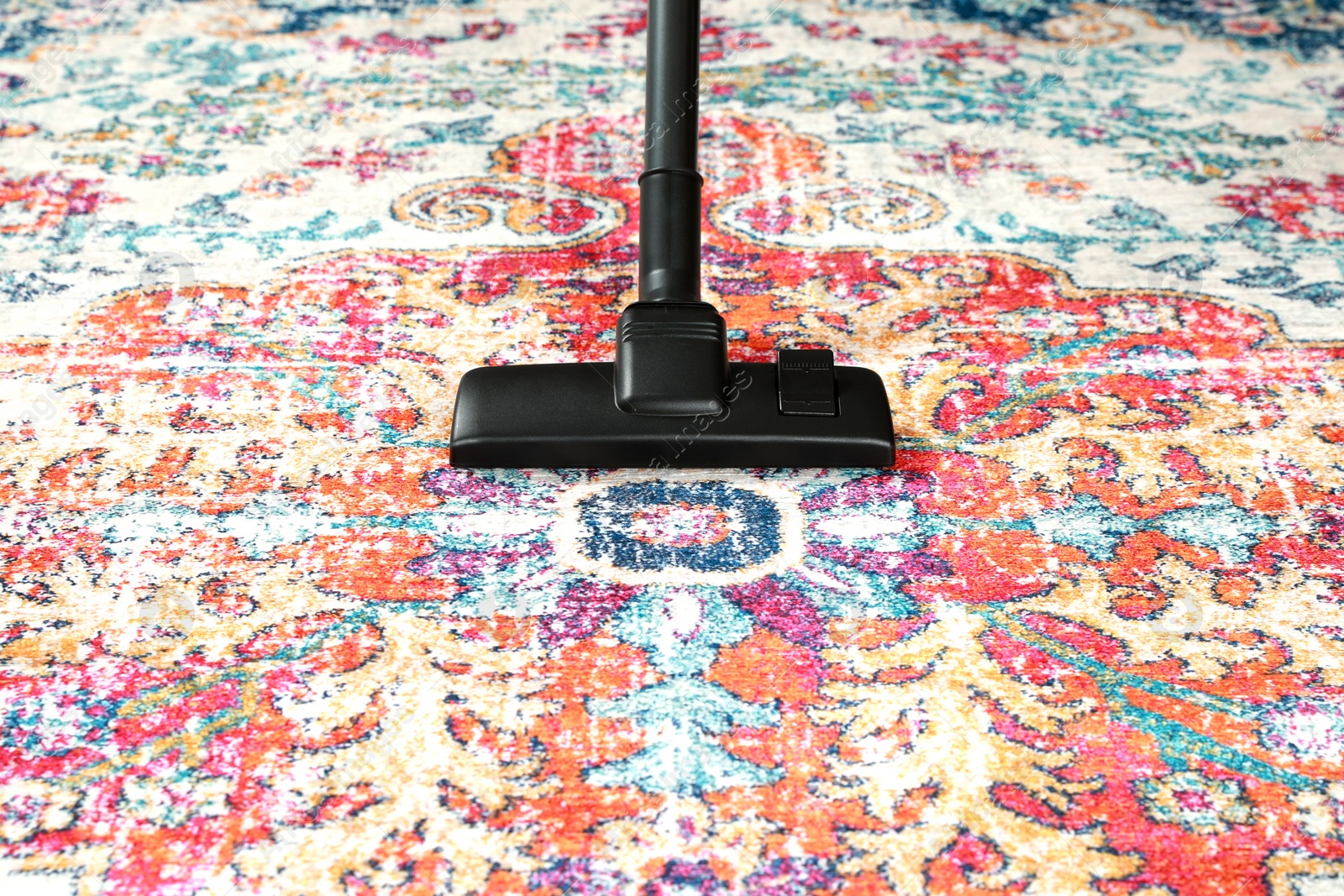 Photo of Removing dirt from carpet with modern vacuum cleaner. Space for text