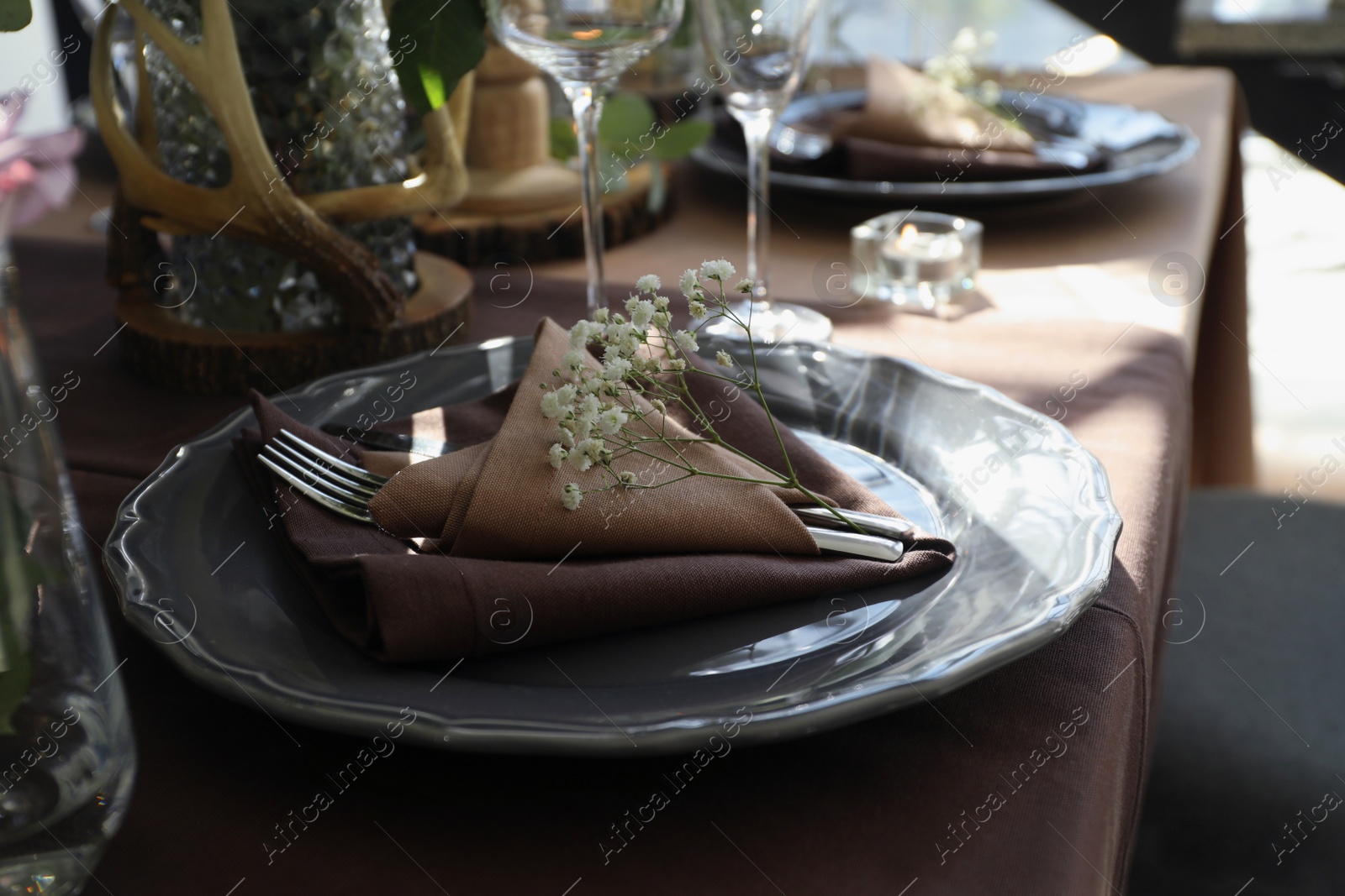 Photo of Festive table setting with beautiful tableware and floral decor indoors