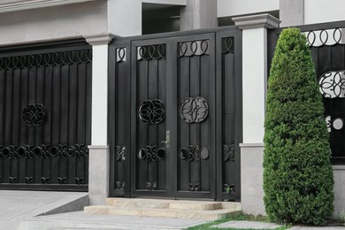 Photo of Entrance of yard with beautiful black metal door