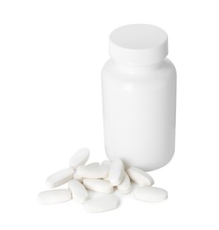 Bottle and pile of vitamin pills isolated on white